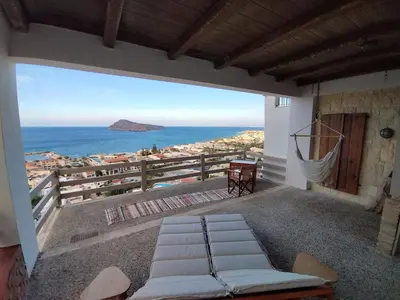 a balcony of a house with a view of the ocean at Meteoron Platanias in Plataniás
