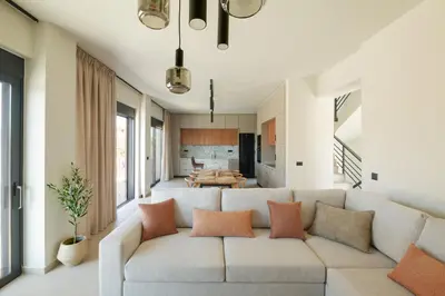 a living room with a couch and a table at Madre Tierra Boutique Villas 3 & 4 in Potistíria