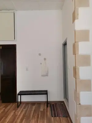a black bench in a room with a white wall at casa di pietra in Chania Town