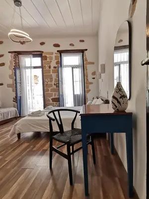 a bedroom with a desk and a bed in a room at casa di pietra in Chania Town