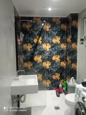 a bathroom with a sink and a wall covered in bananas at Αγίου Φανουρίου 5 γάλατα Χανιά Κρήτης in Galatás