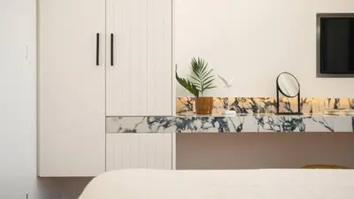 a bedroom with a counter with a sink and a mirror at Two Seaview Villas With Elegant Design in Agios Onoufrios