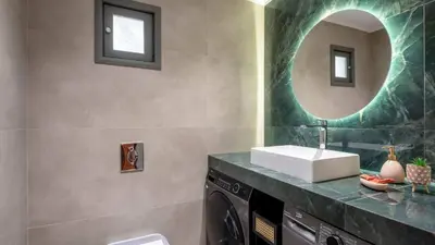 a bathroom with a sink and a mirror at Two Seaview Villas With Elegant Design in Agios Onoufrios
