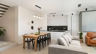 a kitchen and living room with a table and a couch at Two Seaview Villas With Elegant Design in Agios Onoufrios