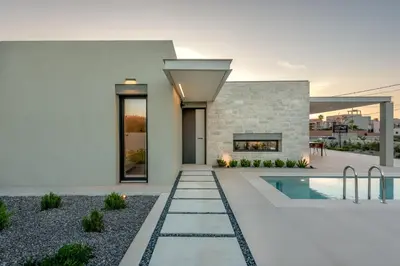 a house with a swimming pool and a fireplace at Deux Olives Luxury Villa in Maleme