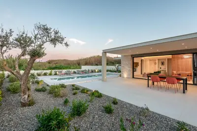 an image of a house with a backyard at Deux Olives Luxury Villa in Maleme