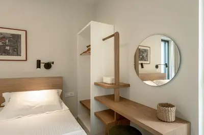 a bedroom with a bed and a mirror at Deux Olives Luxury Villa in Maleme