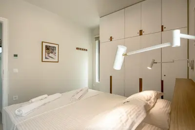a bedroom with a bed with two white towels on it at Deux Olives Luxury Villa in Maleme