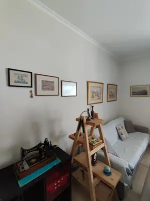 a living room with a couch and a wooden ladder at Downtown house with seaview near to the beach in Chania Town