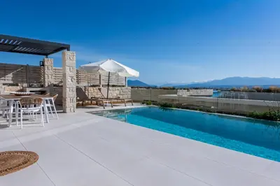 a swimming pool on the roof of a house at Elpida Luxury Villa, private pool, fantastic view! in Stérnai