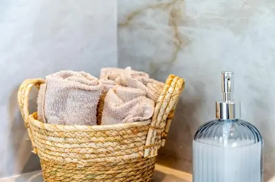 a basket with a bottle of soap and a soap dispenser at Elpida Luxury Villa, private pool, fantastic view! in Stérnai