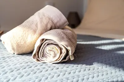 a rolled up towel sitting on top of a bed at Elpida Luxury Villa, private pool, fantastic view! in Stérnai