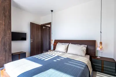 a bedroom with a bed with a blue and white comforter at Elpida Luxury Villa, private pool, fantastic view! in Stérnai