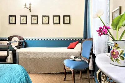 a bedroom with a bed and a table and a chair at House Minoos in Chania Town