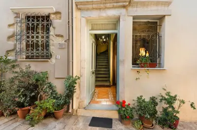 an entrance to a building with potted plants and a door at House Minoos in Chania Town
