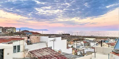 a view of the ocean from the roofs of buildings at House Minoos in Chania Town
