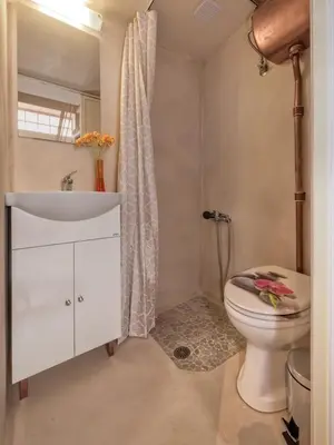 a bathroom with a white sink and a toilet at Rea Studio 1 in Chania Town