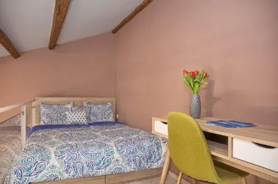 a bedroom with a bed and a desk with a vase of flowers at Rea Studio 1 in Chania Town