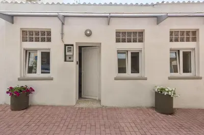 a white house with two windows and a door at Rea Studio 1 in Chania Town