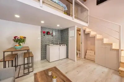 a kitchen and a living room with a staircase at Rea Studio 1 in Chania Town