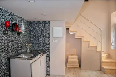 a kitchen with a sink and a staircase at Rea Studio 1 in Chania Town
