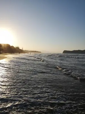 a beach with a group of people in the ocean at SeaREN Apartment in Stalos