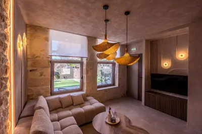 a living room with a couch and a table at HOLM Ilex & Quercus apartments in Chania Town