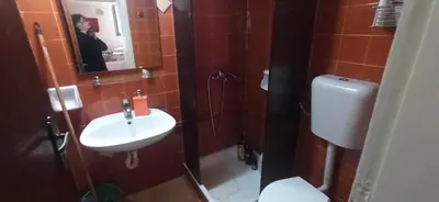 a bathroom with a sink and a toilet and a mirror at 1st floor studio in Kalathas in Kalathas