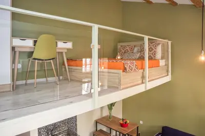 a bedroom with a bunk bed with a desk and a chair at Rea Studio 2 in Chania Town