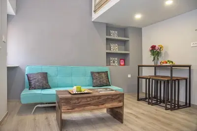 a living room with a blue couch and a coffee table at Rea Studio 3 in Chania Town