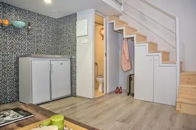 a living room with a staircase and a bathroom at Rea Studio 3 in Chania Town