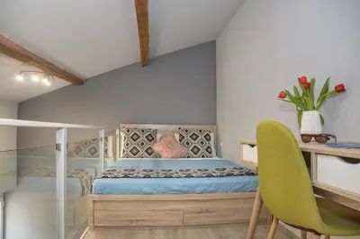 a bedroom with a bed and a desk and a table and chairs at Rea Studio 3 in Chania Town