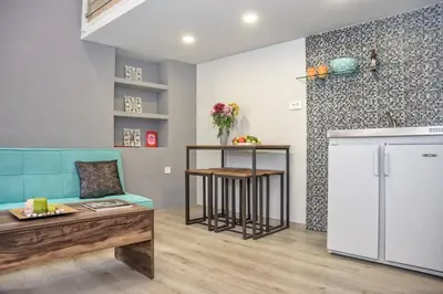a living room with a couch and a refrigerator at Rea Studio 3 in Chania Town