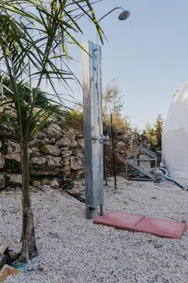 a tent and a red mat next to a tree at Olive Dome, Luxury Glamping Dome in Crete in Gavalochori