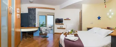 a bedroom with a bed and a desk and a television at Villa Mariposa - panoramic sea view - near Chania city in Chania Town