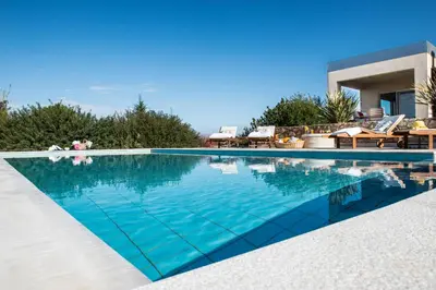 a swimming pool in front of a house at Villa Mariposa - panoramic sea view - near Chania city in Chania Town