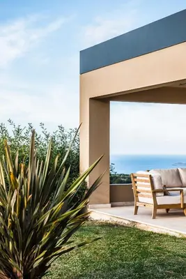 a patio with a bench and a view of the ocean at Villa Mariposa - panoramic sea view - near Chania city in Chania Town