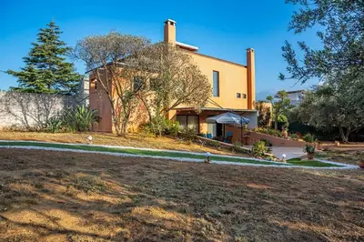 a large house with a yard in front of it at Lithos Serenity in Argoulidhés