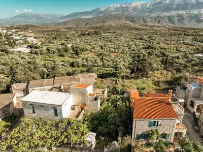 an aerial view of a house with mountains in the background at Agapi's Charming Retreat - Rustic Escape in Chania in Maláxa