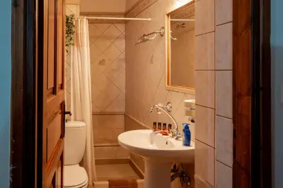 a small bathroom with a sink and a toilet at Agapi's Charming Retreat - Rustic Escape in Chania in Maláxa