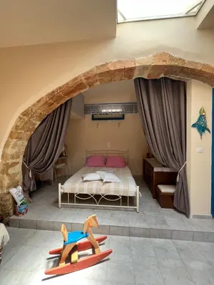 a bedroom with a bed and a large stone arch at Casa Antica