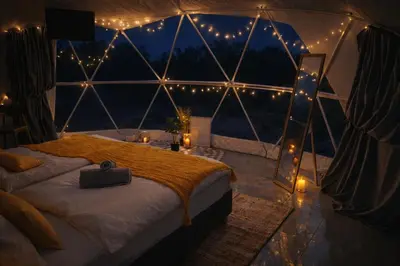 a bedroom with a bed in a tent with lights at Lemon Dome, Luxury Glamping Dome in Crete in Gavalochori