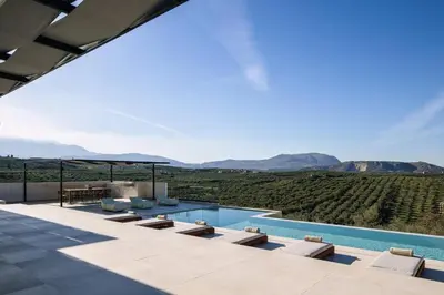 a villa with a pool and a view of the hills at Villa Maninee-Bespoke Villa-Pool -BBQ-Seaview in Chania Town