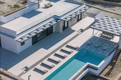 an aerial view of a house with a swimming pool at Villa Maninee-Bespoke Villa-Pool -BBQ-Seaview in Chania Town