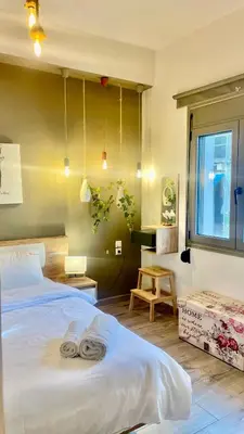 a bedroom with a bed with two towels on it at Garden house by Dreams in Chania Town