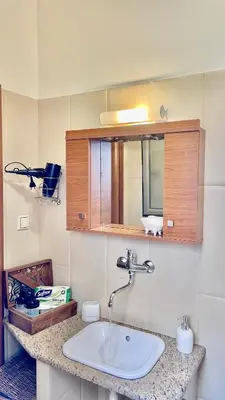 a bathroom with a sink and a mirror at Garden house by Dreams in Chania Town