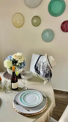 a table with a plate and a bottle of wine at Garden house by Dreams in Chania Town