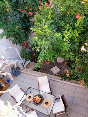 an overhead view of a table and chairs with a bowl of fruit at Garden house by Dreams in Chania Town