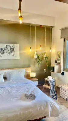 a bedroom with a bed with two towels on it at Garden house by Dreams in Chania Town