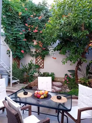 a table with a bowl of fruit on a patio at Garden house by Dreams in Chania Town